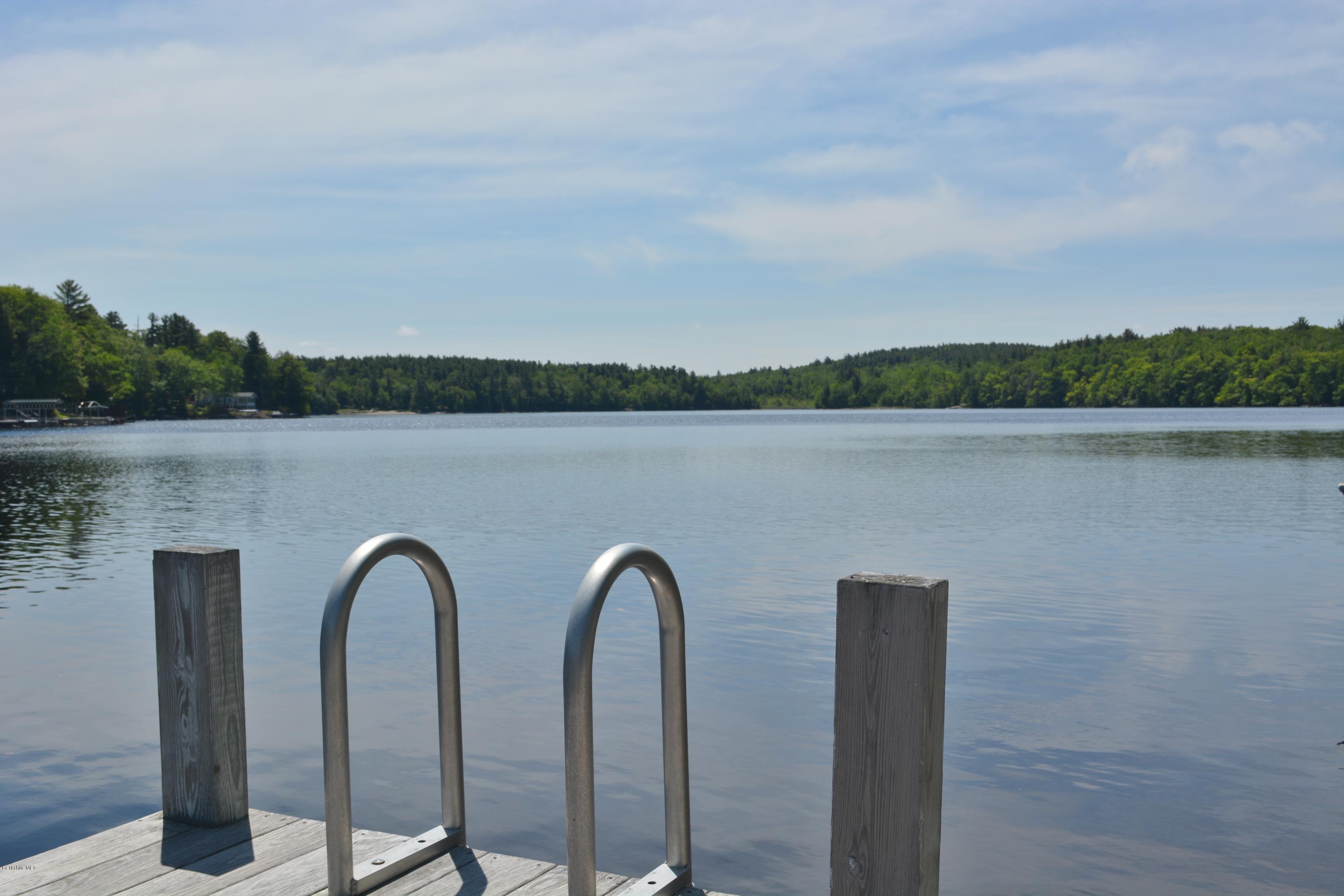87 North Gate Island Road Otis, MA 01029 - Photo 3 of 15 a view of a lake with a couple of large trees