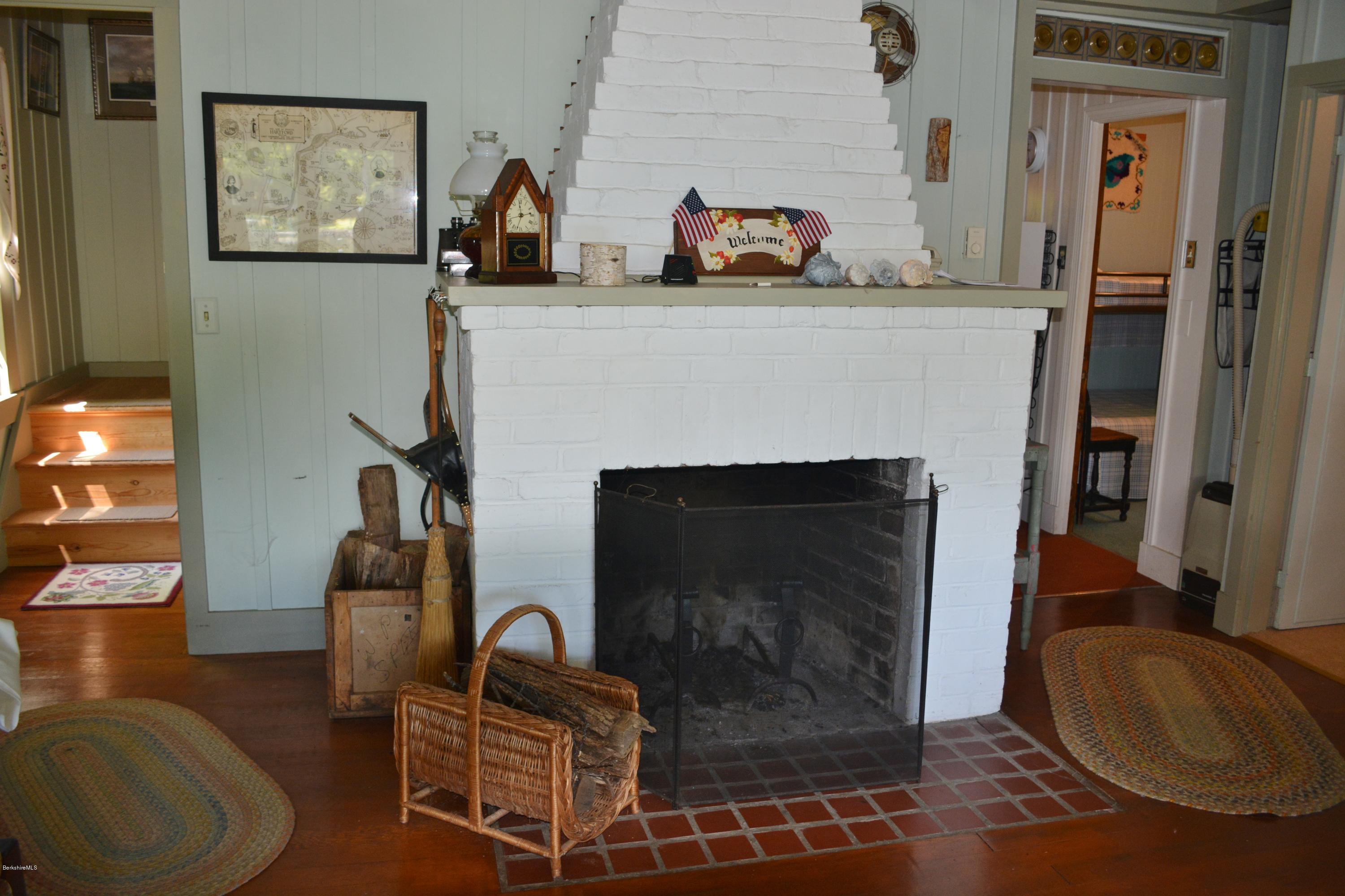87 North Gate Island Road Otis, MA 01029 - Photo 6 of 15 a living room with furniture a flat screen tv and a fireplace