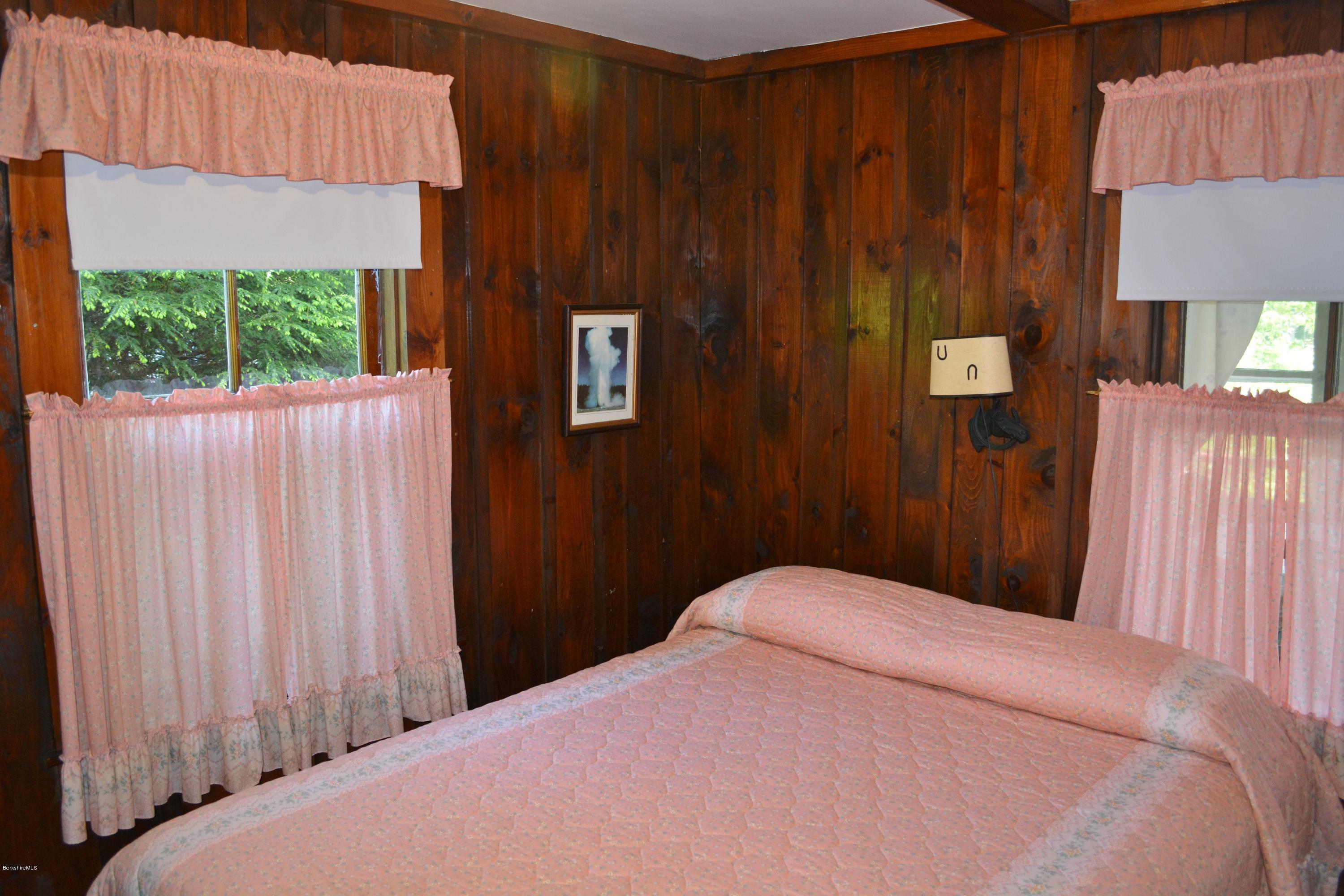 87 North Gate Island Road Otis, MA 01029 - Photo 8 of 15 a bedroom with a bed and a window
