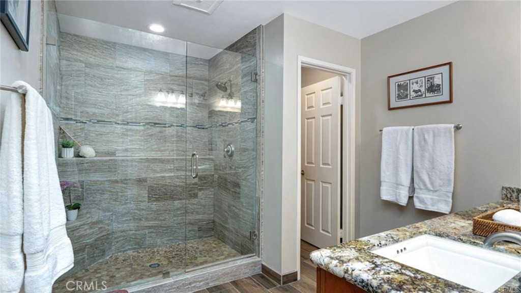 8 Oakgrove, Unit 54 Irvine, CA 92604 - Photo 12 of 14 a bathroom with a granite countertop sink a toilet and shower