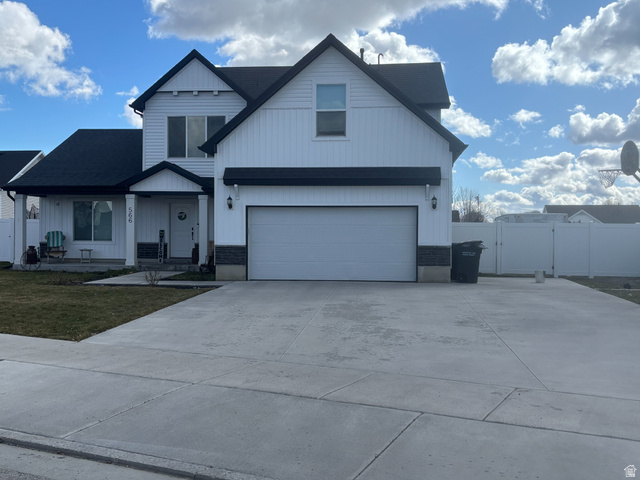566 Saddleback Road Smithfield, UT 84335 - Photo 1 of 1 View of front of home with a gate, covered porch, driveway, board and batten siding, and a garage