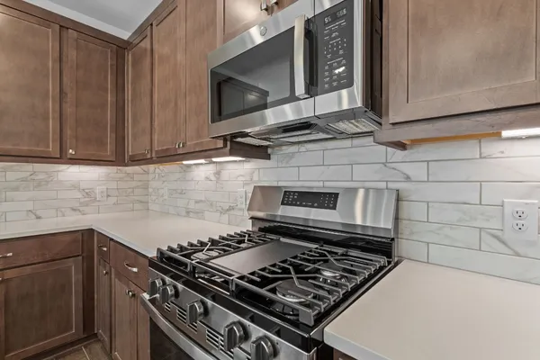 a stove top oven sitting inside of a kitchen