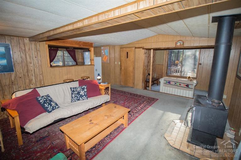 16804 Covina Road Bend, OR 97707 - Photo 7 of 16 a living room with furniture and a floor to ceiling window
