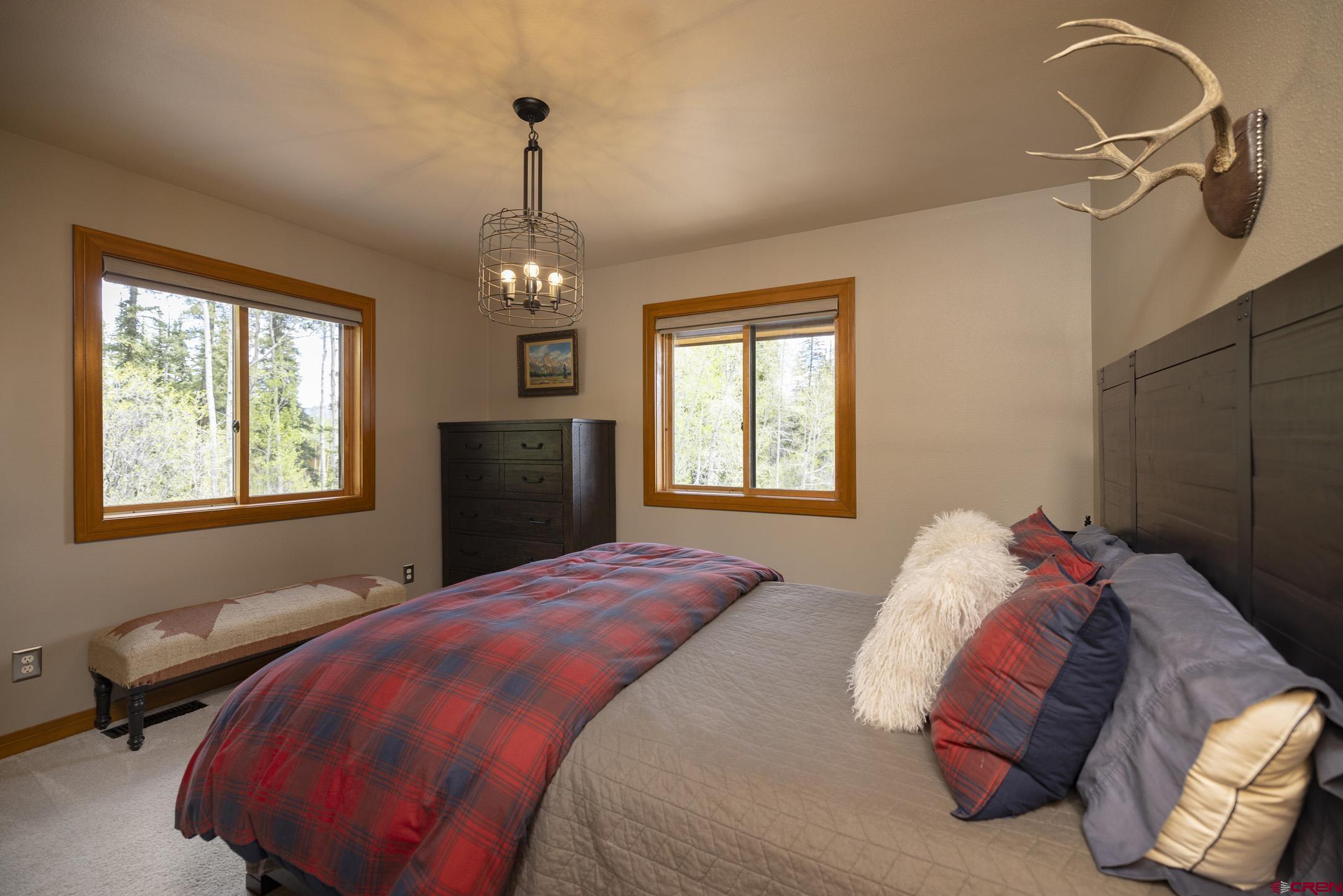 154 Falcon Ridge Road Durango, CO 81301 - Photo 22 of 42 a bedroom with a bed and window