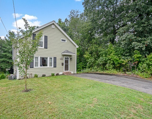 80 Hillcrest Road Waltham, MA 02451 - Photo 19 of 20 a white house with a small yard and trees in the background