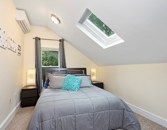 80 Hillcrest Road Waltham, MA 02451 - Photo 9 of 20 a bedroom with a large bed and a window