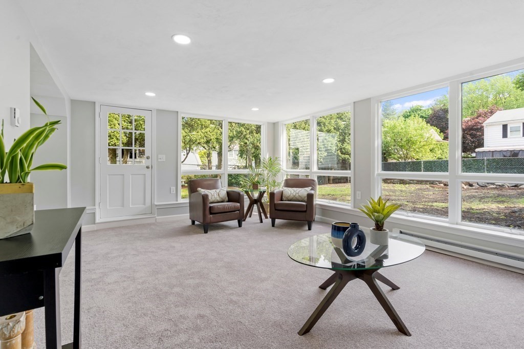 6 Glen Road Peabody, MA 01960 - Photo 22 of 35 a living room with furniture and a floor to ceiling window