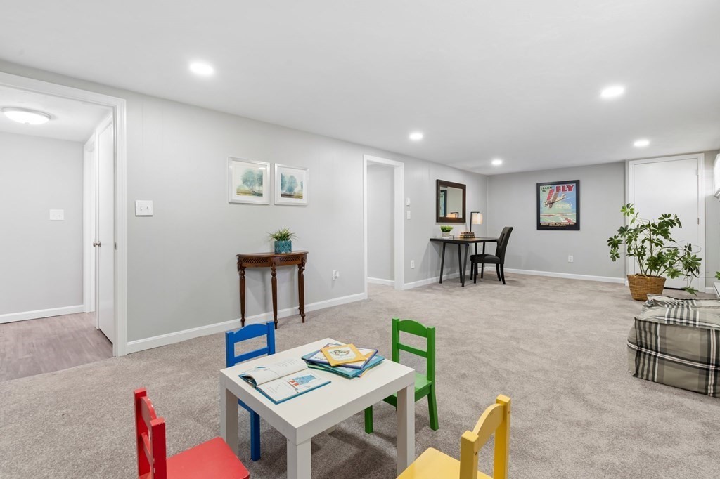 6 Glen Road Peabody, MA 01960 - Photo 24 of 35 a living room with furniture and a dining table with wooden floor