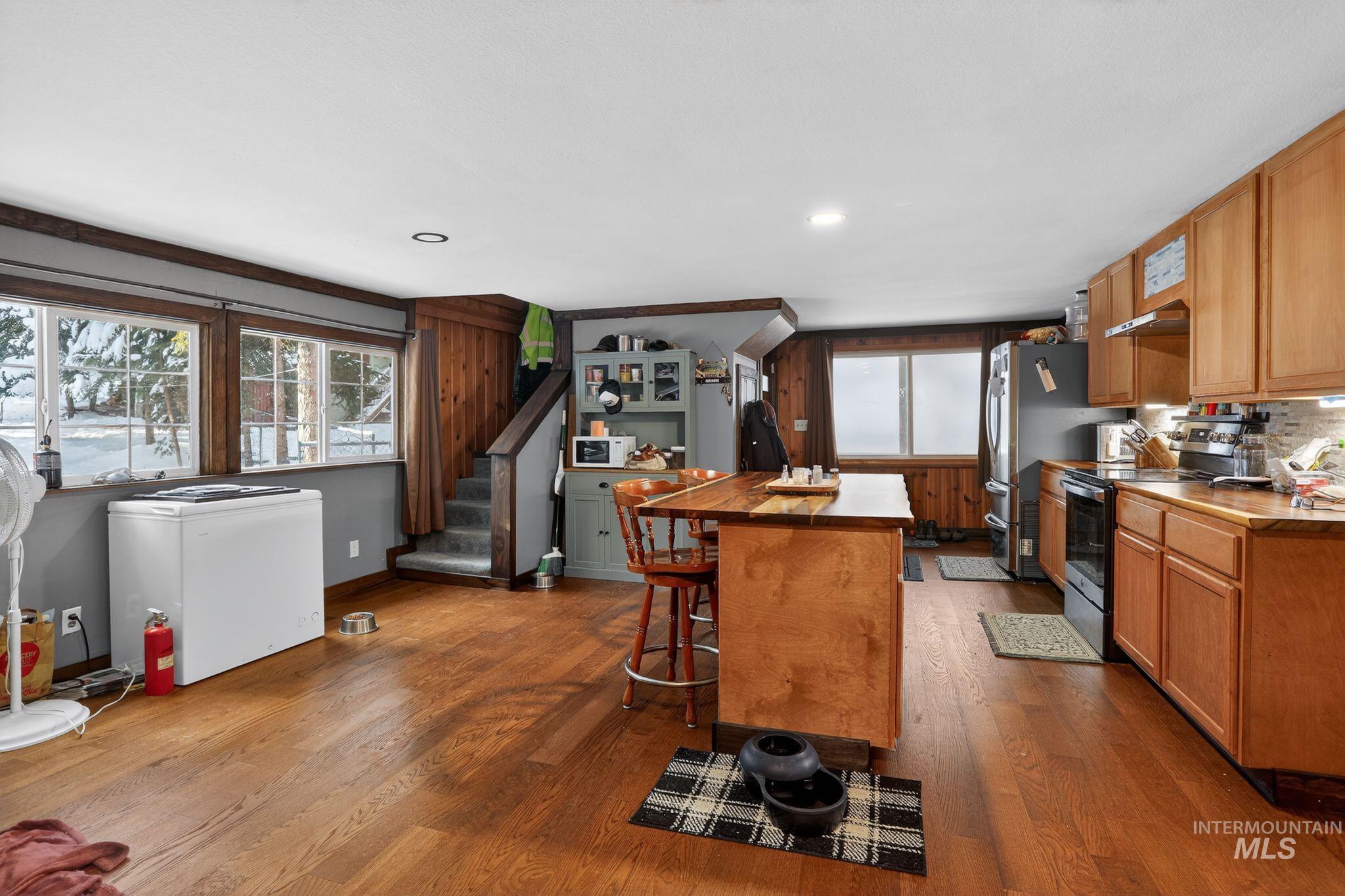 654 Bings Road Cascade, ID 83611 - Photo 10 of 45 Kitchen with electric stove, a breakfast bar area, dark wood-type flooring, a kitchen island, and recessed lighting