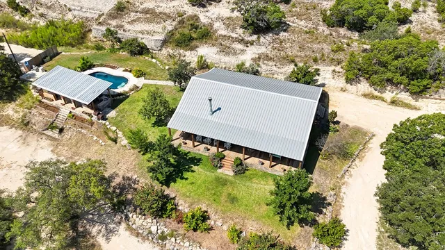 an aerial view of a house with garden space and street view