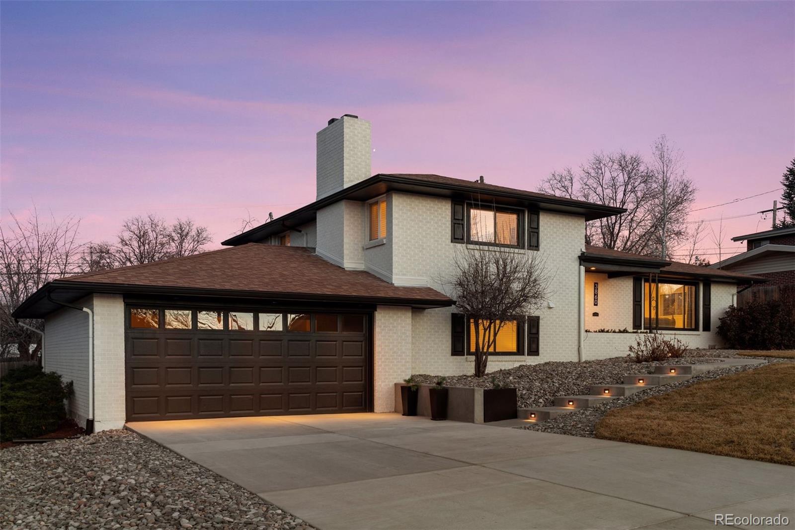 3860 Dudley Street Wheat Ridge, CO 80033 - Photo 2 of 38 a front view of a house with a yard