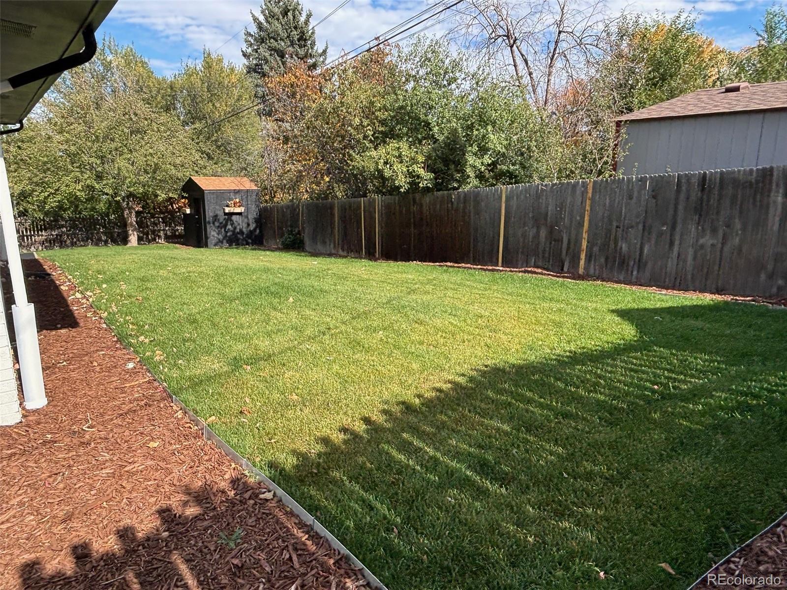 3860 Dudley Street Wheat Ridge, CO 80033 - Photo 38 of 38 a view of a backyard with a garden