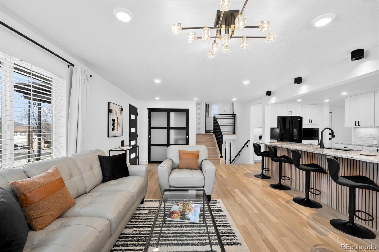 3860 Dudley Street Wheat Ridge, CO 80033 - Photo 5 of 38 a living room with furniture a rug and white walls