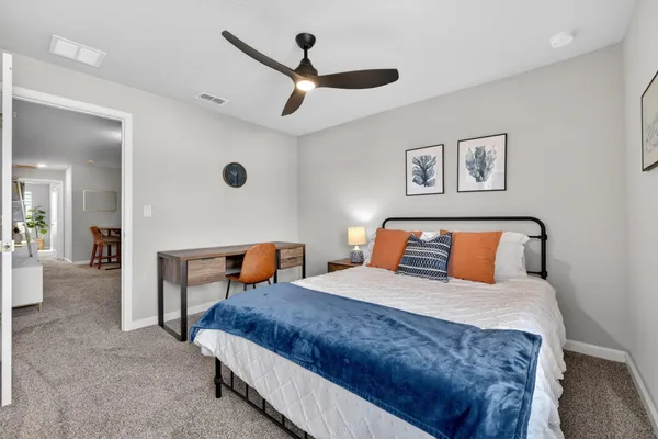 a bedroom with a bed and a chair