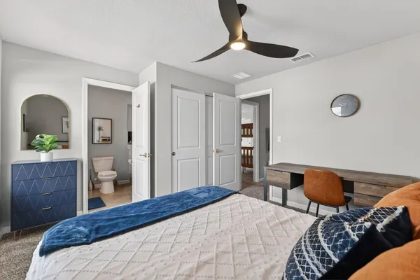 a bedroom with furniture and a window