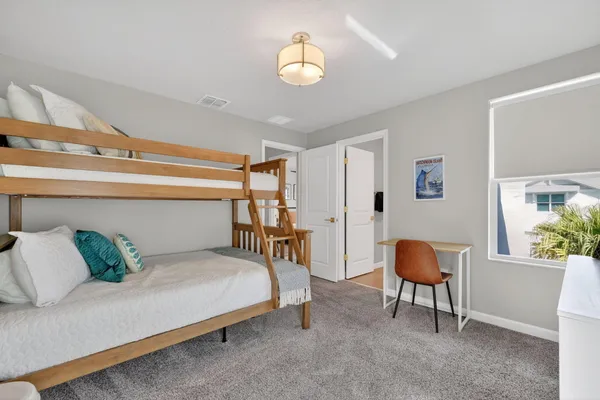 a bedroom with furniture and a window
