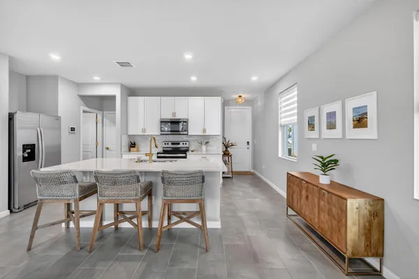 a kitchen with stainless steel appliances granite countertop a refrigerator and a stove top oven