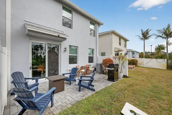an outdoor sitting area with furniture and wooden floor
