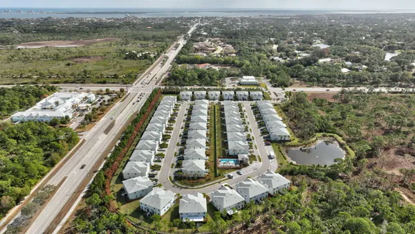 an aerial view of residential houses with outdoor space