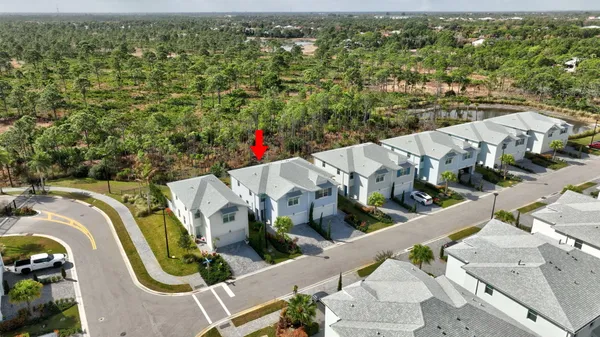 an aerial view of residential houses with outdoor space