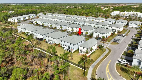 an aerial view of residential houses with outdoor space