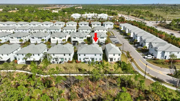 an aerial view of residential houses with outdoor space and street view