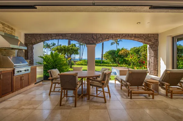 a view of a patio with table and chairs potted plants