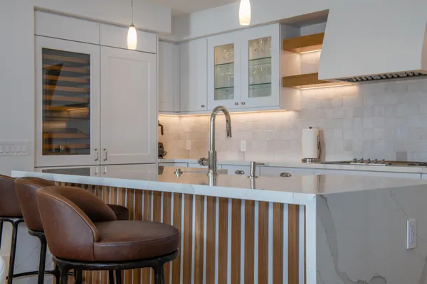 a kitchen with a chair a table and chairs