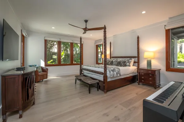 a spacious bedroom with a bed and large windows