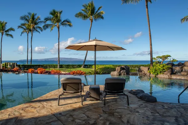 a swimming pool with outdoor seating