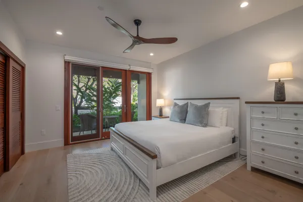a large bedroom with a large bed and a large window