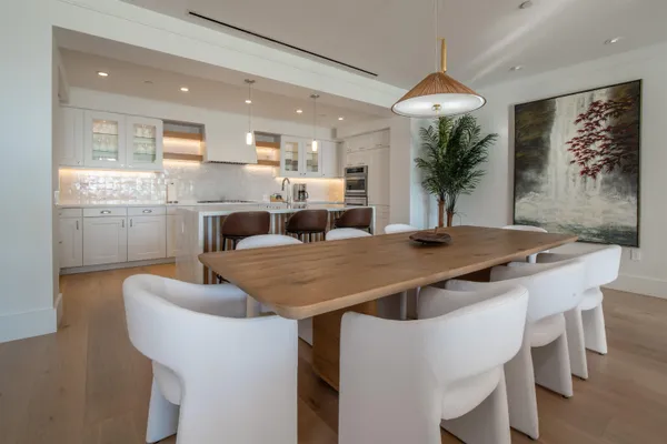 a dining table with chairs and window