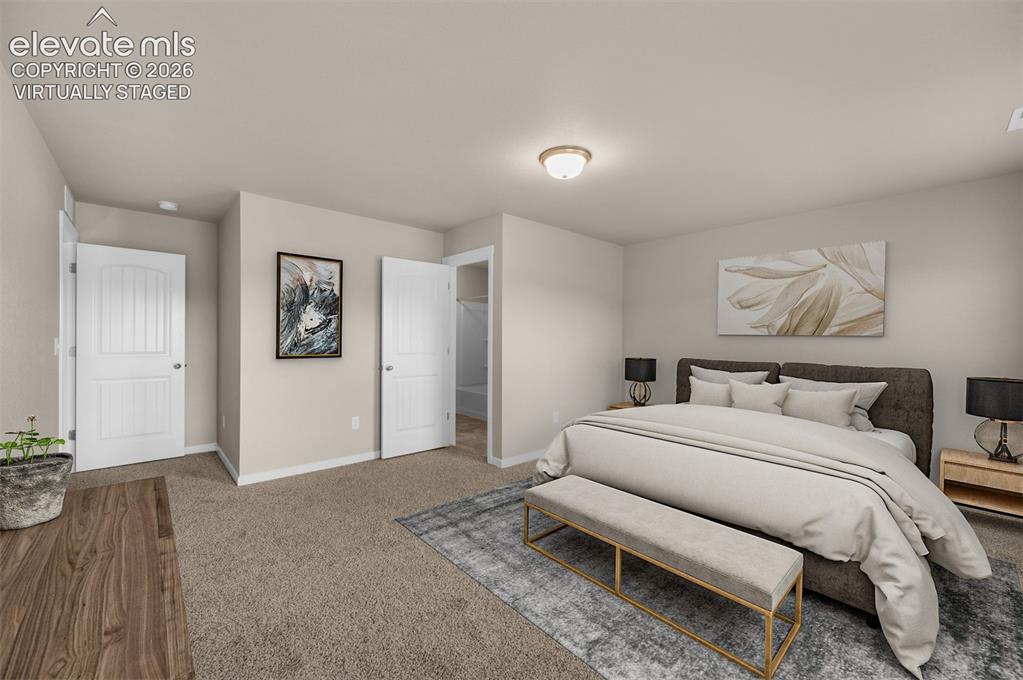 6644 Rawhide Rdg View Colorado Springs, CO 80915 - Photo 20 of 26 a bedroom with a bed and a chandelier
