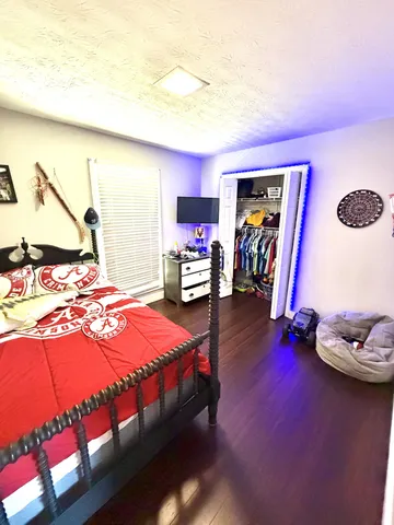 a bedroom with a bed and ceiling fan
