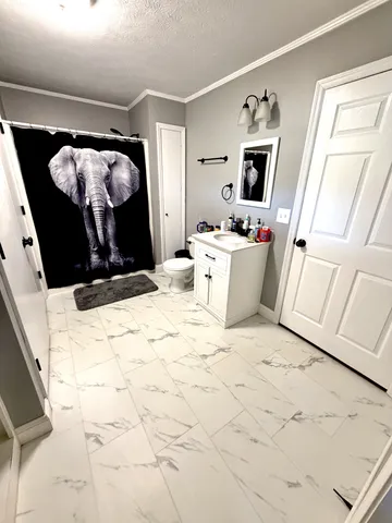 a bed room with a bed window and a dresser