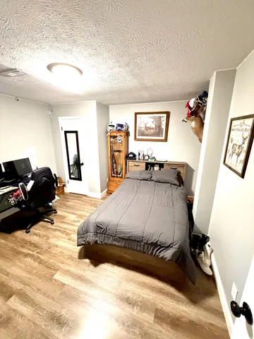 a bedroom with a bed and a dresser