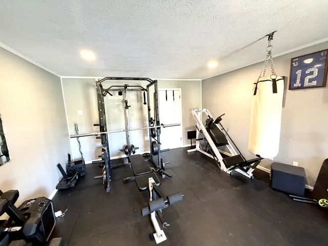 a room with gym equipment and mirrors