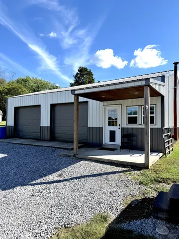 a house with green field in front of it