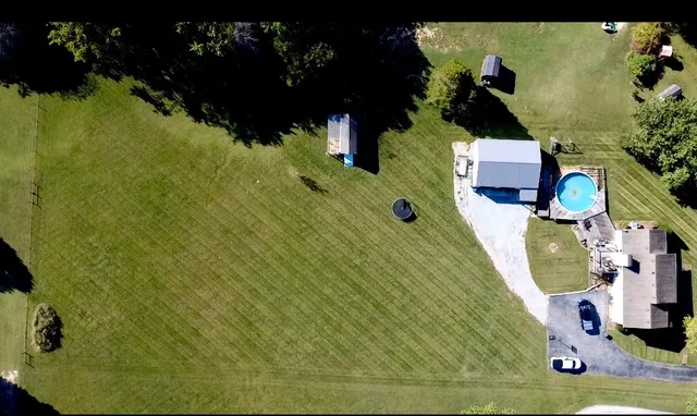 a view of a swimming pool with a yard