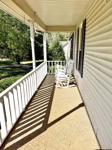 a view of balcony with wooden floor and iron stairs