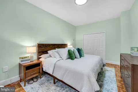 a bedroom with a bed and a night stand