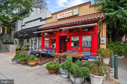 a view of a cafe with sitting area