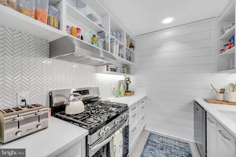 a kitchen with stainless steel appliances granite countertop a stove and a sink