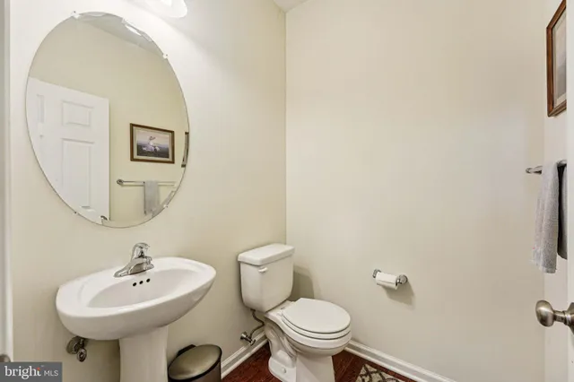 a bathroom with a sink mirror and toilet