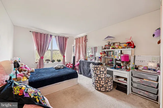 a living room with furniture toys and a window
