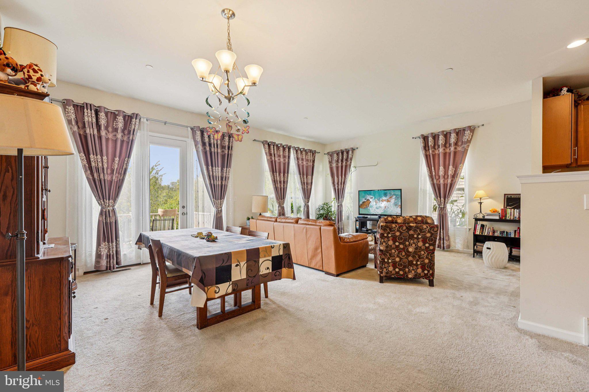 332 Redbud Lane Kennett Square, PA 19348 - Photo 5 of 29 a living room with furniture a fireplace and a chandelier