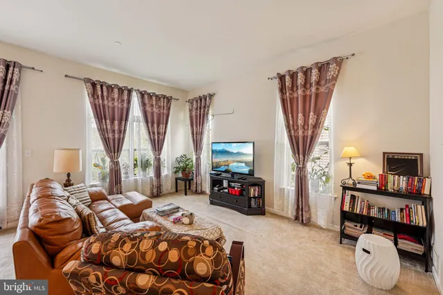 a bedroom with a bed closet and a flat tv screen