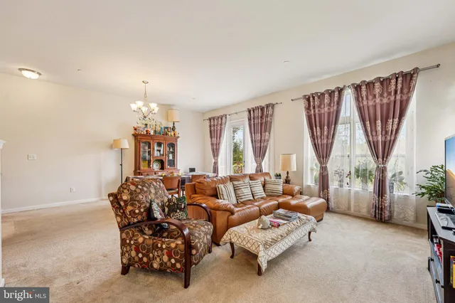 a spacious bedroom with furniture and a large window