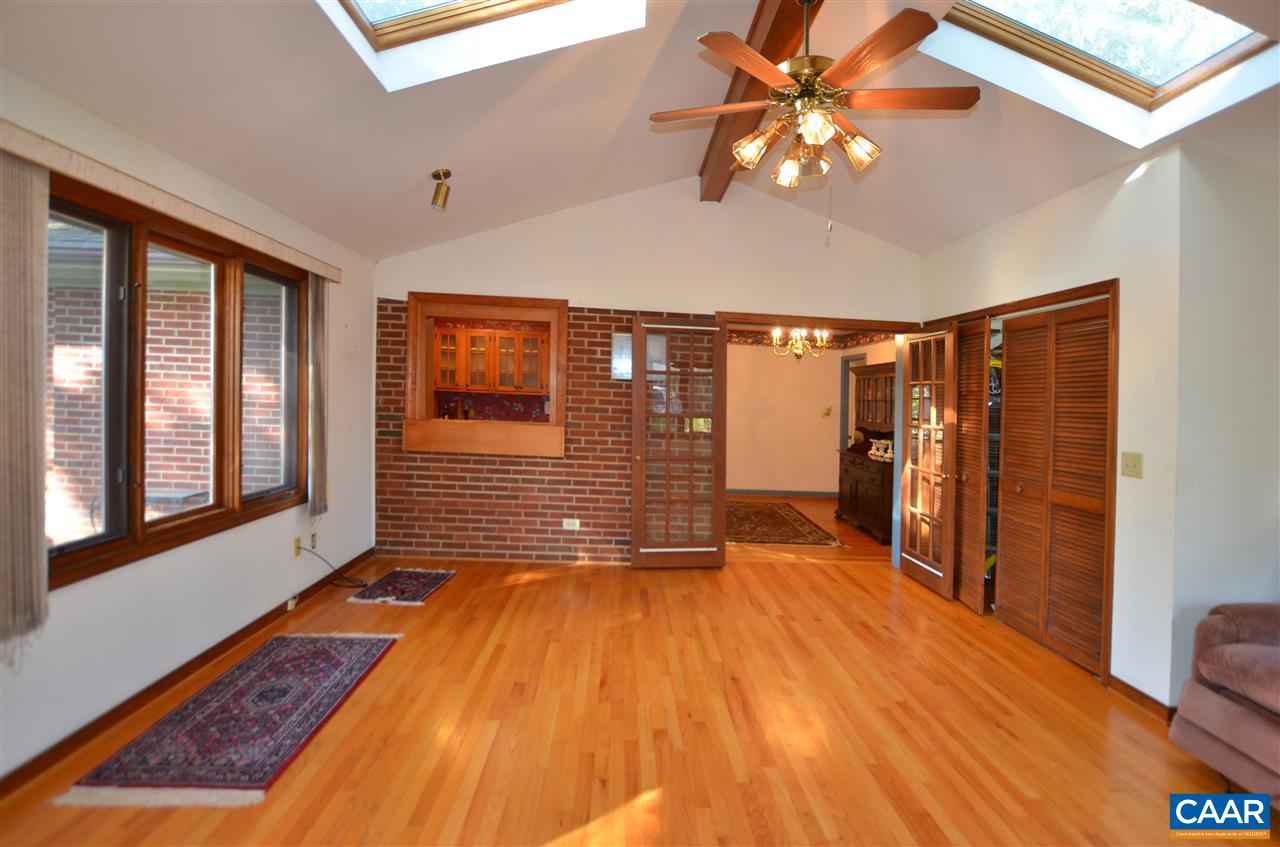 5770 Willow Spring Road Crozet, VA 22932 - Photo 18 of 49 a view of a livingroom with wooden floor and a ceiling fan