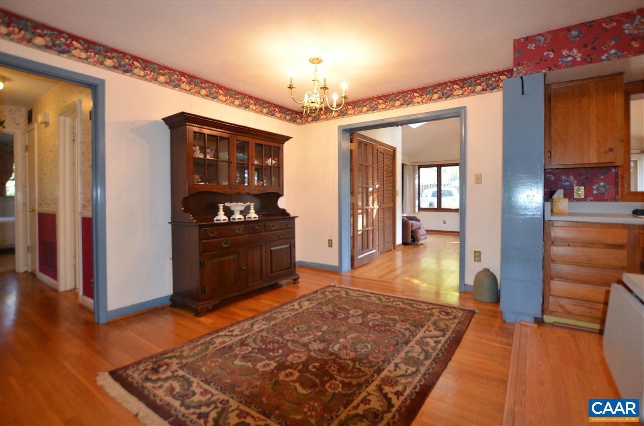 5770 Willow Spring Road Crozet, VA 22932 - Photo 32 of 49 a living room with a rug and a chandelier